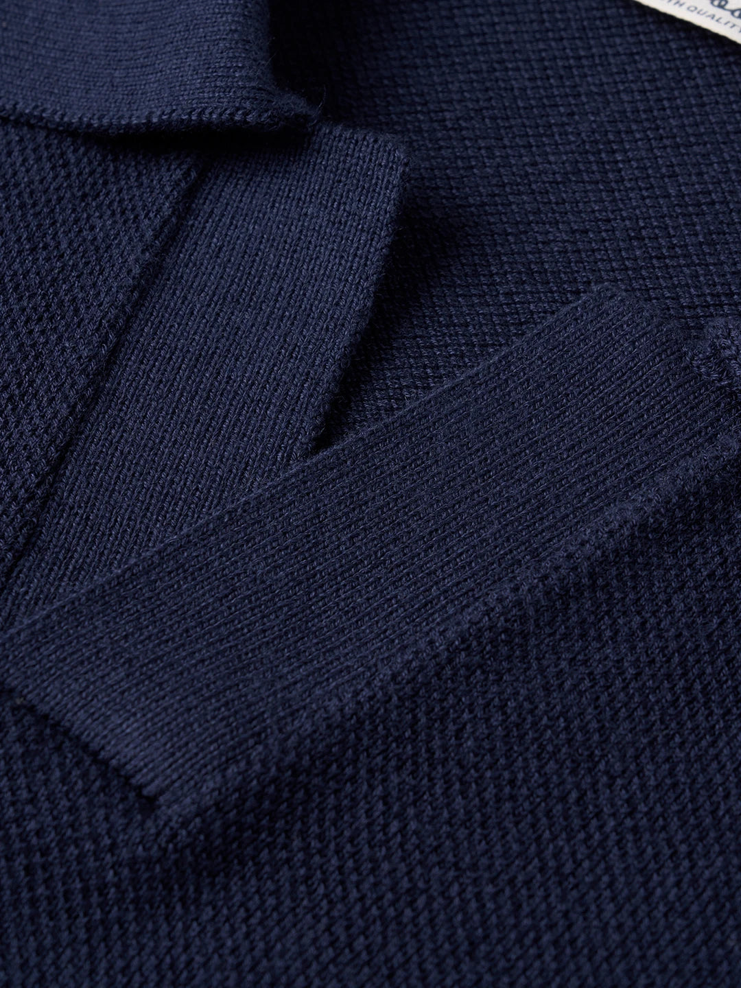 Navy blue knit polo shirt with textured fabric and ribbed collar detail