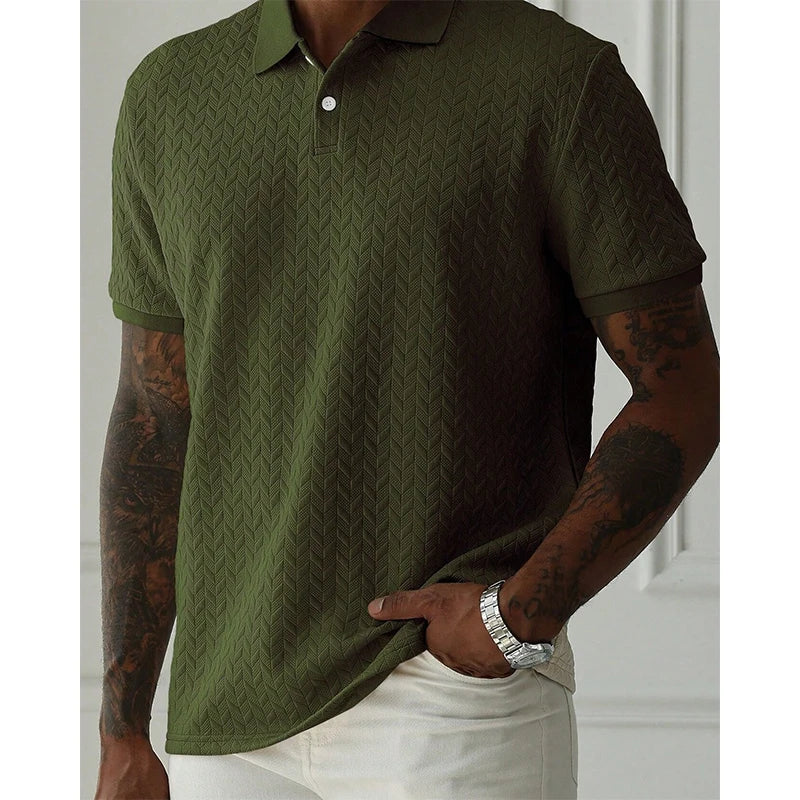 Olive green textured polo shirt with herringbone pattern, styled with white pants for casual streetwear look