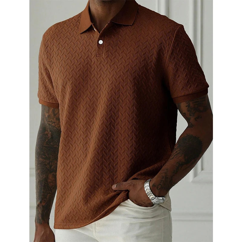 Brown textured polo shirt with herringbone pattern, worn with white pants for casual streetwear style